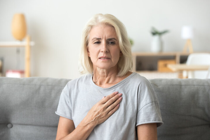 older woman feeling heartache