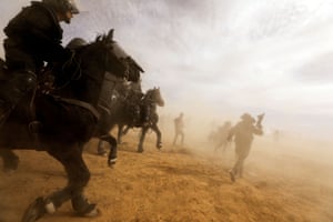 Israeli security forces advance during a protest held by Bedouins against tree-planting by the Jewish national fund on disputed land near Bedouin village of al-Atrash in the Negev desert.