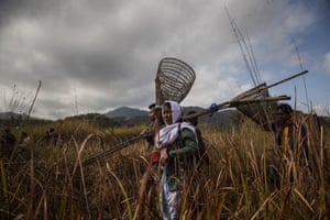 Villagers arrive to participate in community fishing as part of Bhogali Bihu celebrations in the village of Panbari.